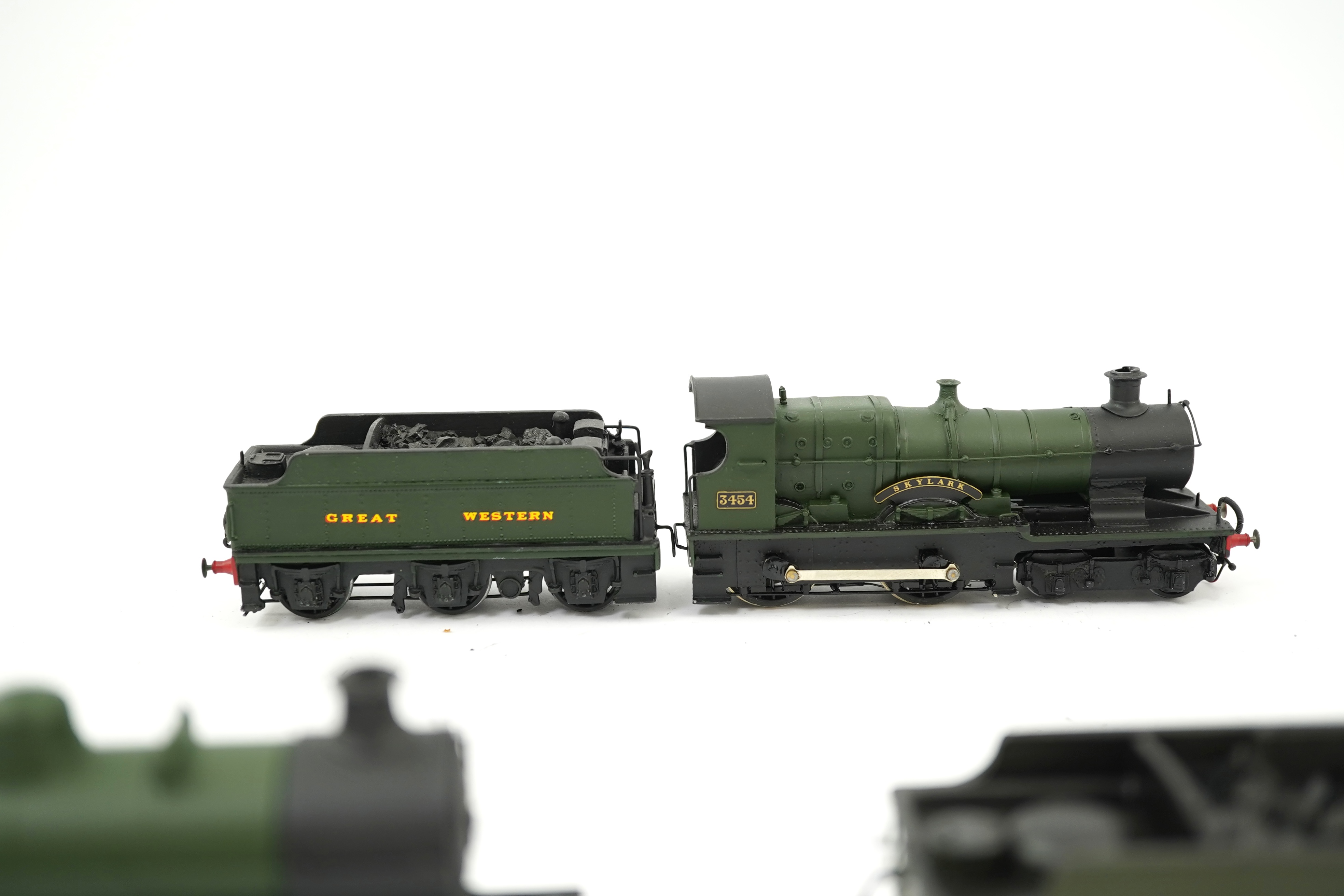 Three 00 gauge brass and white metal kit built GWR tender locomotives; a 2884 class 2-8-0, 2884, together with an 33xx class 4-4-0, 3454, and a War Dept. 2-8-0, 3012, all constructed, painted and lined to a high standard